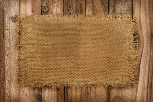 Rustic background of Burlap material on a wooden table with copy space — Stock Photo, Image