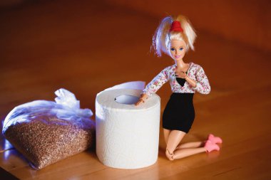 Coronavirus. Tuvalet kağıdı ve karabuğdayla çeşitli pozlarda Barbie bebek..