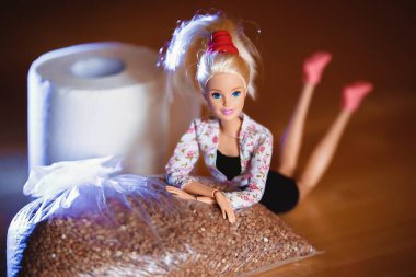 Coronavirus. Tuvalet kağıdı ve karabuğdayla çeşitli pozlarda Barbie bebek..