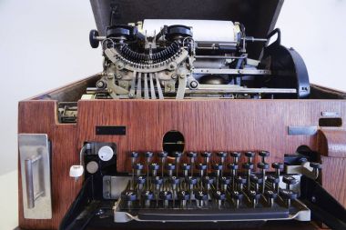 Antique typewriter/telex machine build in wooden box clipart