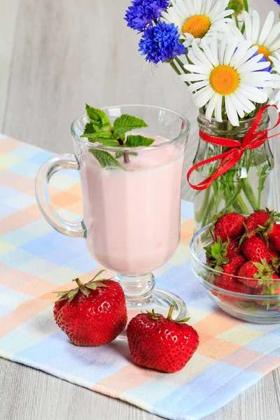 Склянка йогурту з м'ятою та свіжою полуницею, ромашкою та — стокове фото