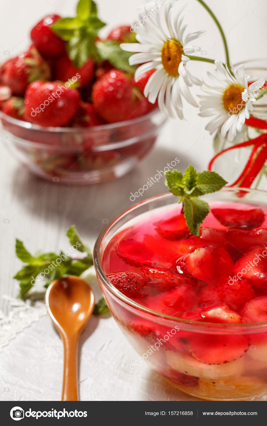 cherry jelly with strawberry pieces in the glass bowl topped min