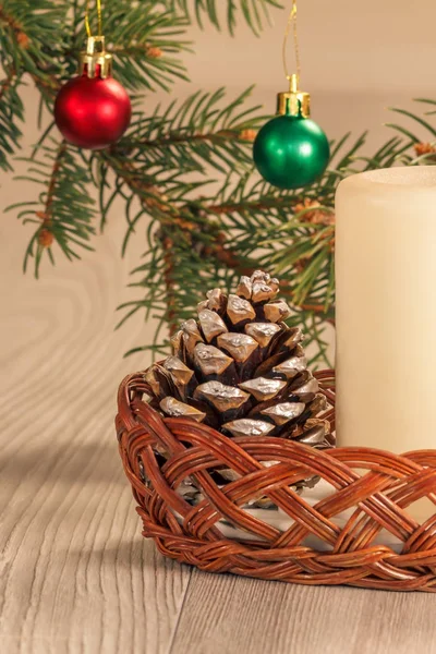 Cone, candle and natural fir tree branches with Christmas orname — Stock Photo, Image