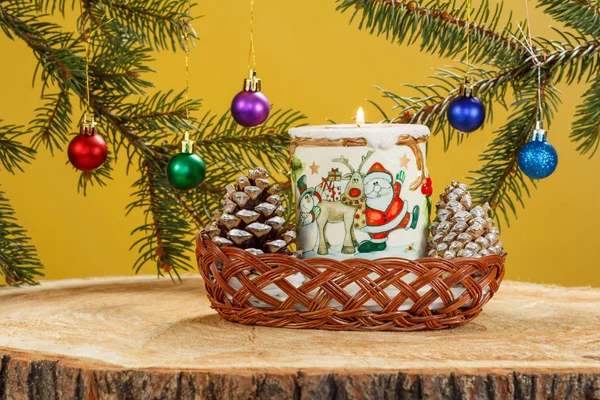 Burning candle, cones and natural fir tree branches with Christm Stock Photo