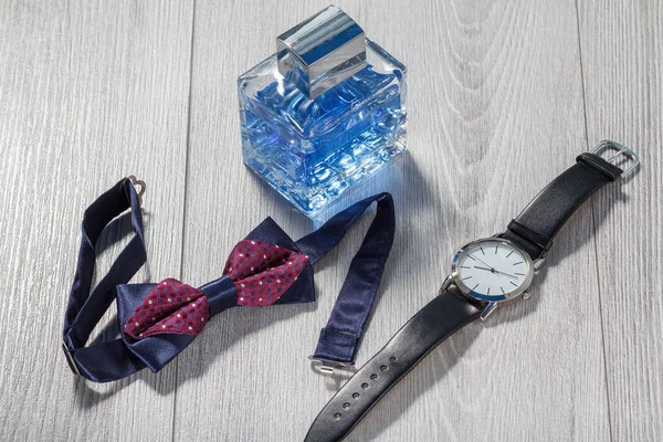 Man perfume, watch with a black leather strap and bow tie