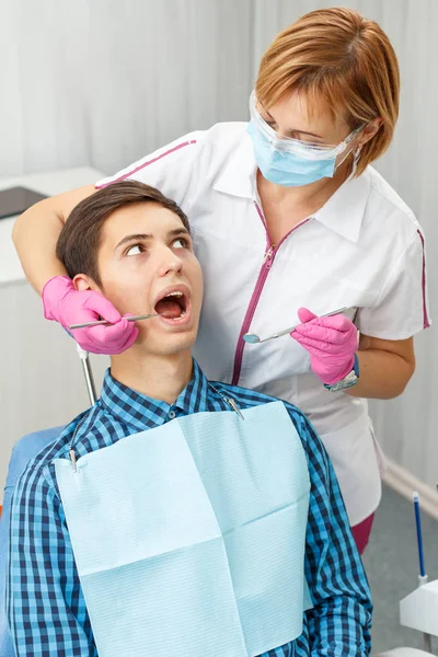 Handsome young man in visit at the dental office. Dentistry