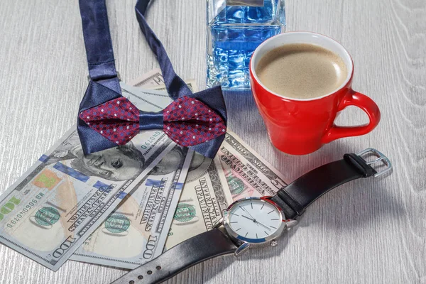 Man perfume, bow tie, cup of coffee, watch with a black leather