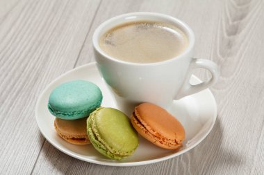 Fincan kahve, lezzetli macarons kek wh üzerinde farklı renk