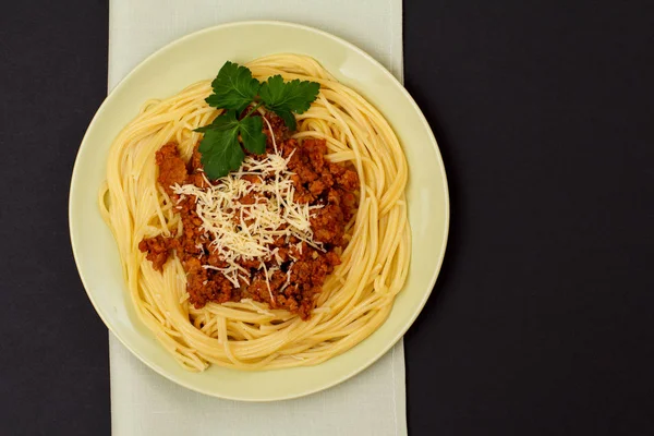 Espaguetis boloñesa en un plato con servilleta de cocina . —  Fotos de Stock