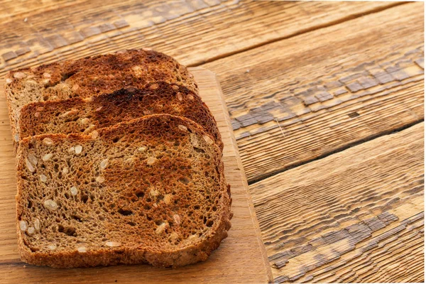 Toasts on wooden cutting board and wooden boards. — Stock Photo, Image