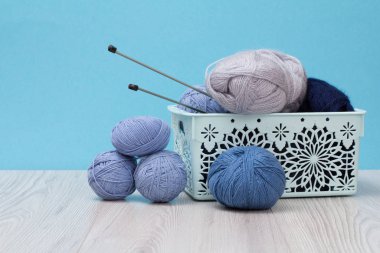 Örgü örmek için yün iplik. Doğal yün yumakları ve örgü iğneleri.