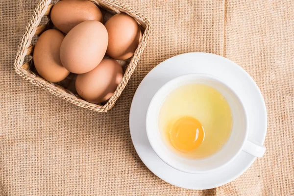 Bez arka plan üzerinde beyaz fincan taze yumurta.