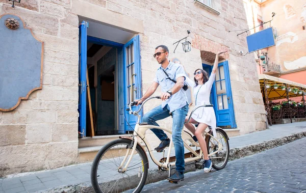 Young couple on tandem bicycle at the street city — Stock Photo, Image