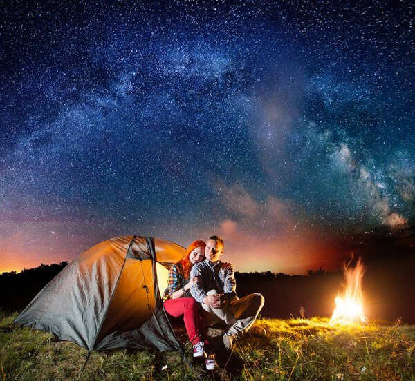 Night camping. Charming couple tourists 
