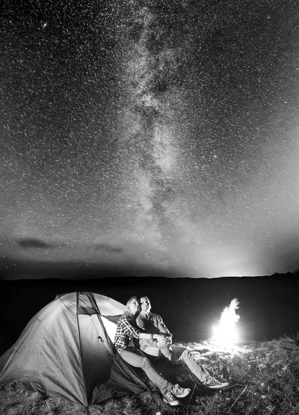 Jóvenes excursionistas mirando al cielo estrellado —  Fotos de Stock
