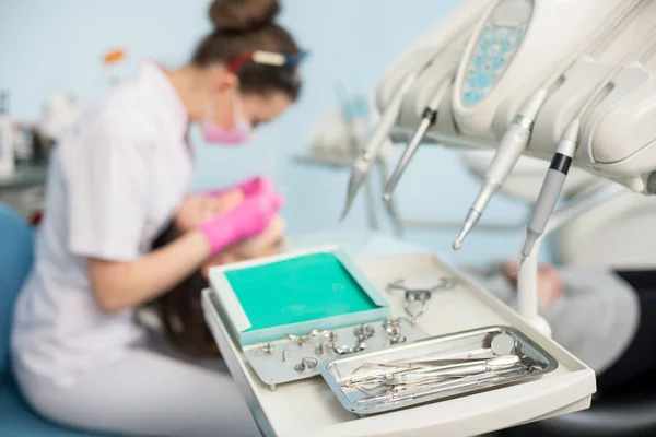 Dentiste féminine traitant les dents des patients — Photo