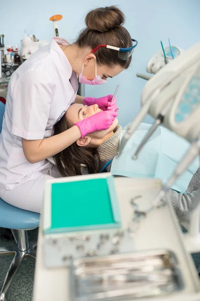 Female dentist treating patient teeth