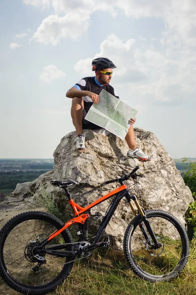 Handsome bicyclist with route map