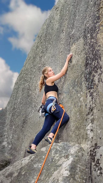 Жінка скелелазіння з мотузкою на скелястій стіні — стокове фото