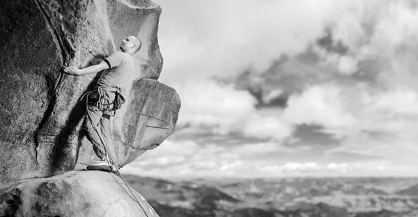 Kletterer klettert mit Seil auf großen Felsbrocken in der Natur — Stockfoto