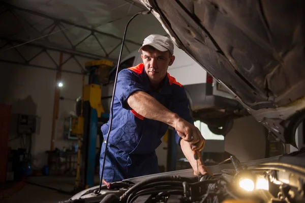 Car mechanic working in auto repair service. Repairing car using — Stock Photo, Image
