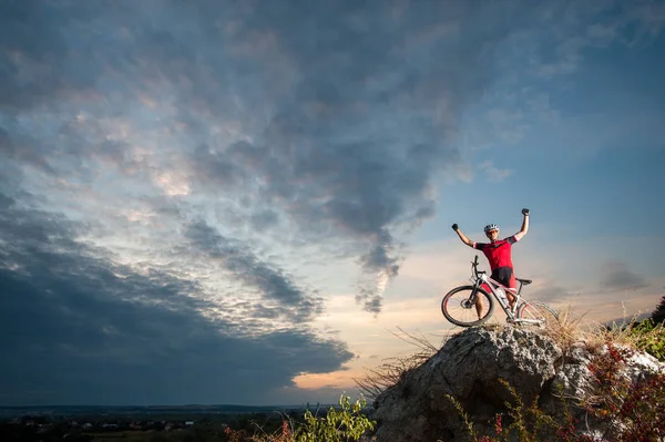 cross country biker relaxing on the top of the mountain