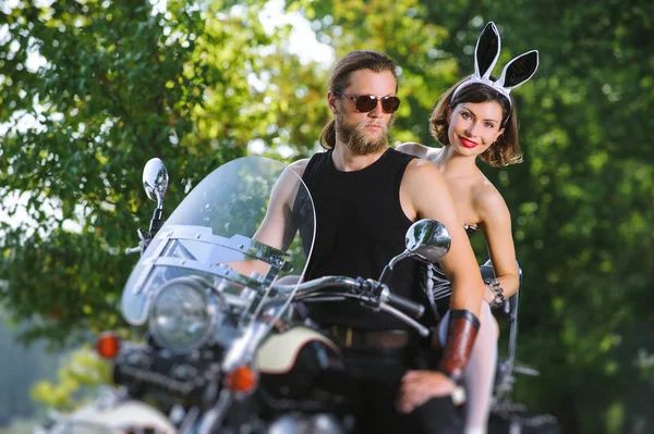 Portrait of sexy couple of bikers on the motorcycle