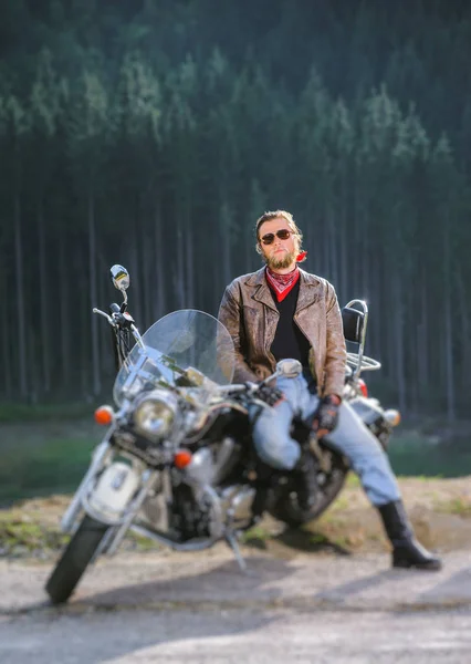 Biker standing by his custom made cruiser motorcycle — Stock Photo, Image