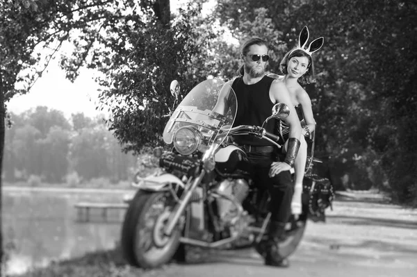 Portrait of brutal biker and beautiful sexy woman on motorcycle