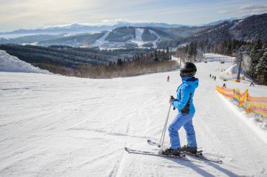 Genç güzel kadın kayakçı Kayak pistinin ortasında