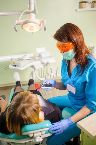 Γυναίκα οδοντίατρος με οδοντίατρο Φωτοπολυμερικές λαμπτήρα — Φωτογραφία Αρχείου