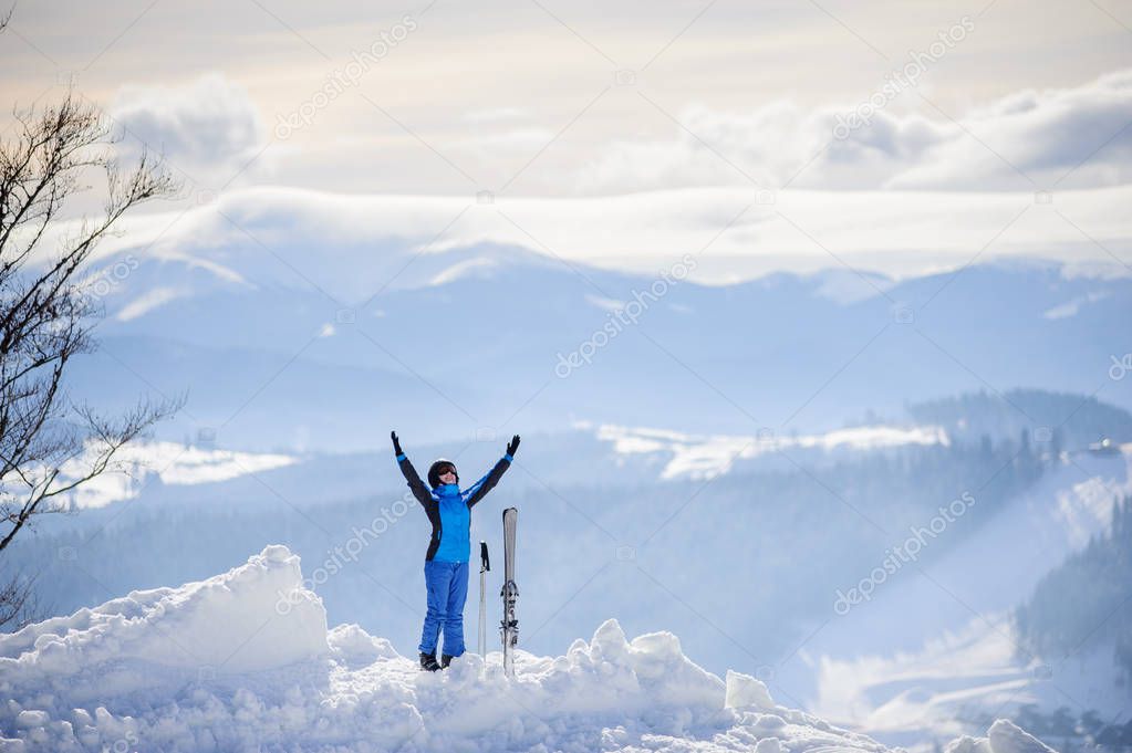 Woman skier on top of the mountain. Winter sports concept