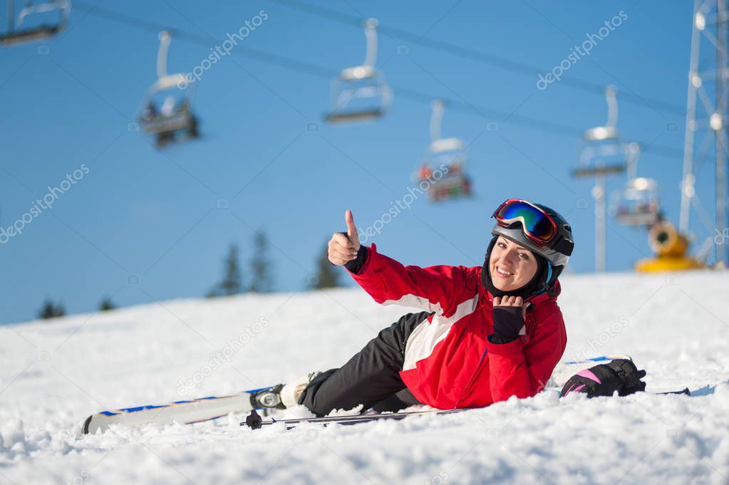 Woman skier with ski at winer resort in sunny day
