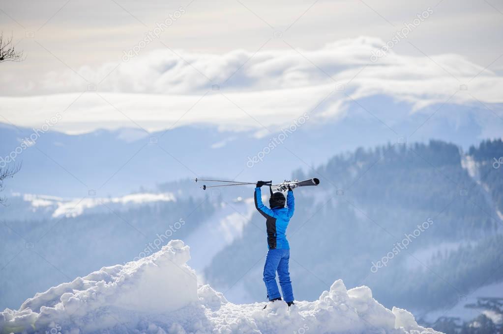 Woman skier on top of the mountain. Winter sports concept