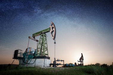 Oil pump on the oil field in the night clipart