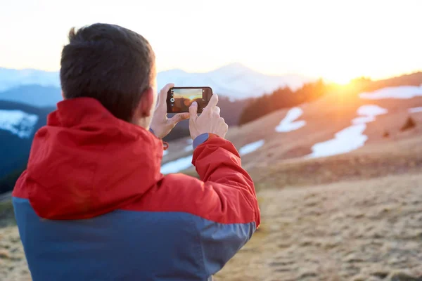 Man taking picture in mountains