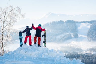bir dağın tepesinde snowboard