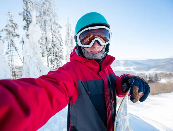man snowboarder taking a selfie