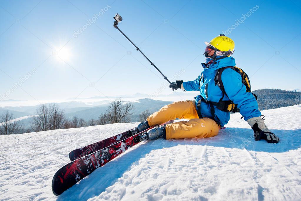 Skier sitting  taking a selfie