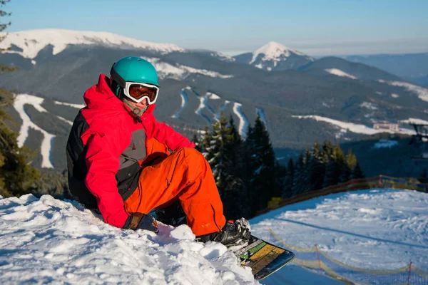 Snowboarder αναπαύεται στην κορυφή του βουνού — Φωτογραφία Αρχείου