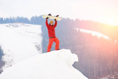man with snowboard in hands clipart