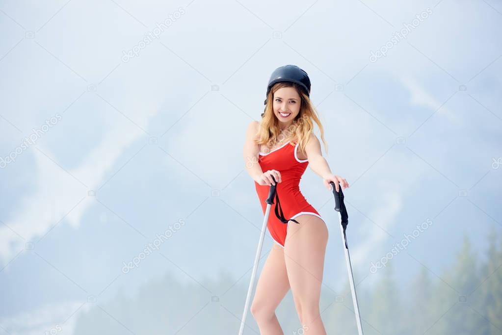 girl skiing in swimsuit and helmet