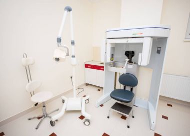 Dental X-ray unit and panoramic radiography machine in a dental office clipart