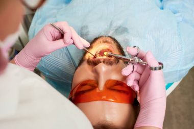 Adam hasta açık ağızlı Close-Up diş hekimi, bir enjeksiyon modern diş kliniğinde alır.