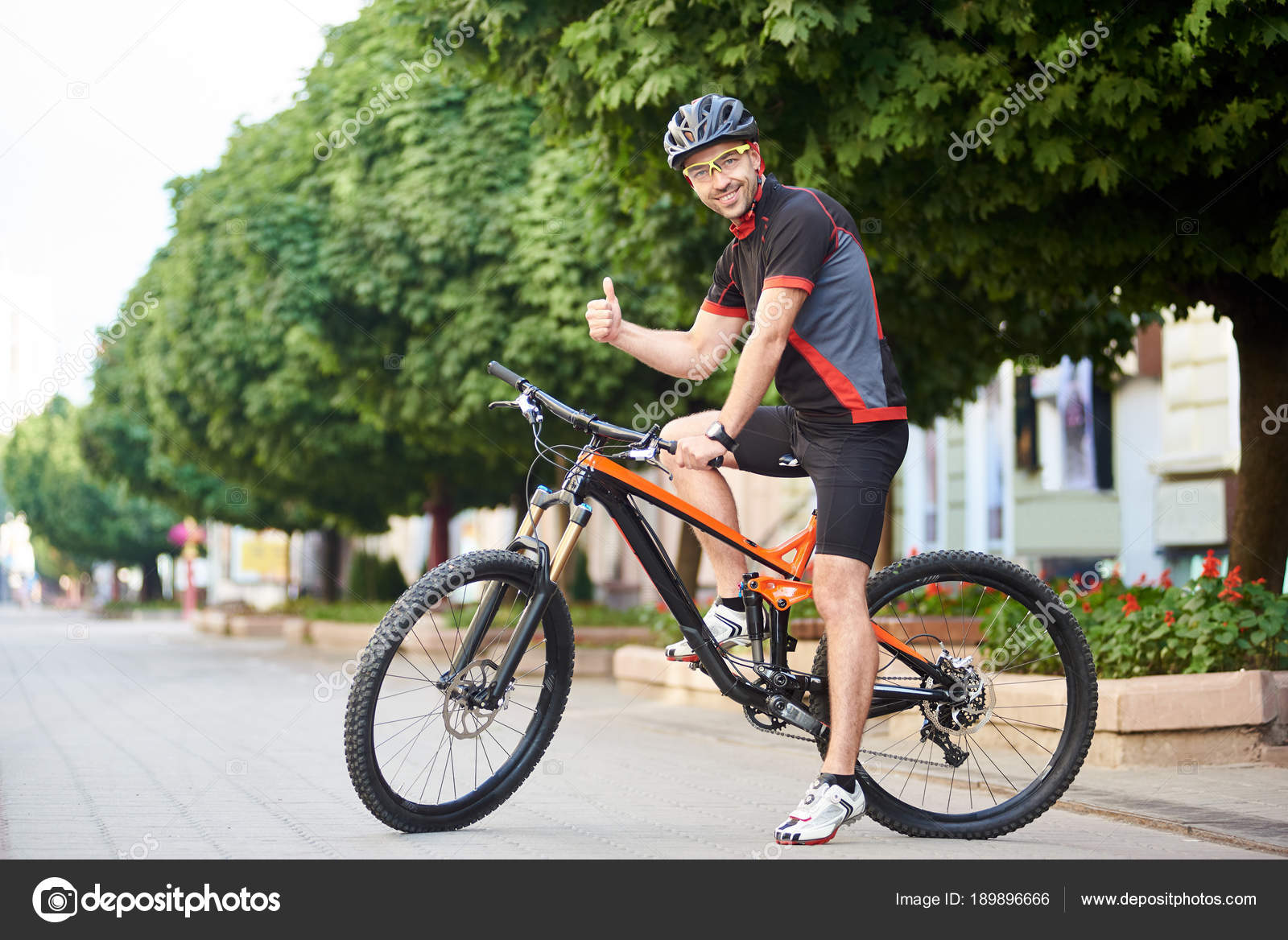 Happy Man Cyclist Professional Cycling Clothing Protective Garment Showing  Thumbs Stock Photo by ©anatoliy_gleb 189896666