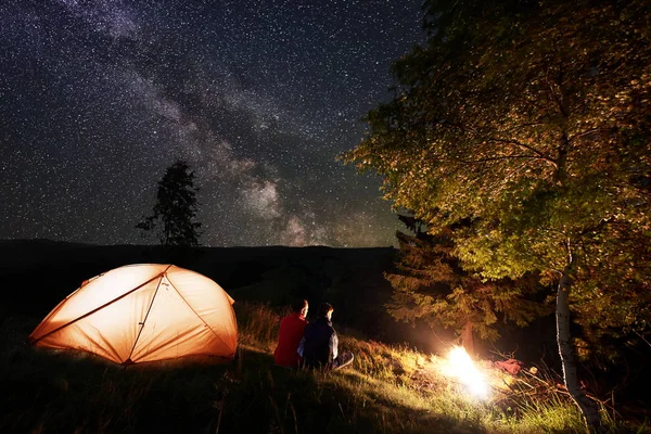 Back View Guy Girl Hikers Sitting Orange Glowing Tent Looking — Stock Photo, Image