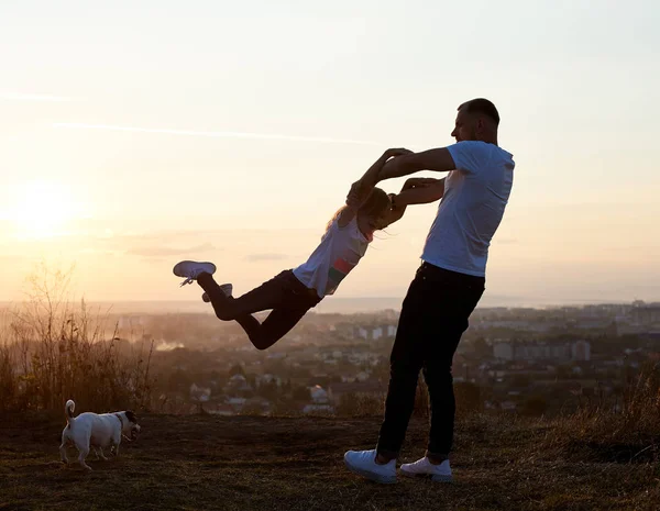 Silhouette Father Swinging His Daughter Arms Hill Setting Sun Suburbs — Stock Photo, Image