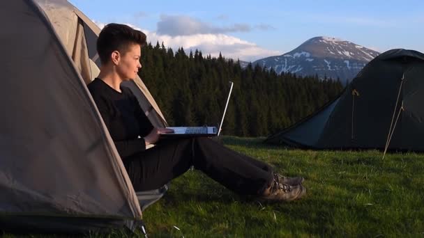 Female Works Laptop Finishes Closes While Sitting Tent Camping Mountains — ストック動画