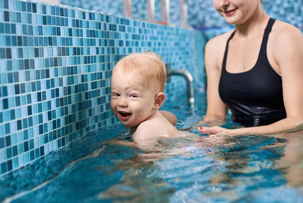 Veselý Blonďatý Chlapec Snaží Plavat Stříbrnou Dýmkou Bazénu Jeho Matka — Stock fotografie