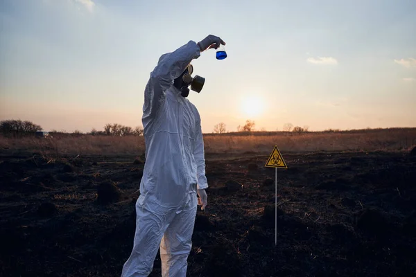 Male Ecologist Radiation Suit Gas Mask Holding Test Tube Blue — Stock Photo, Image